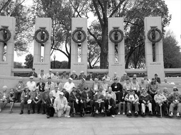 AT THE WWII MEMORIAL - Veterans from Herkimer County pose in front of the World War II Memorial in Washington, D.C., on Friday. Bystanders cheered the group and used the veterans' cameras to take photographs for them.